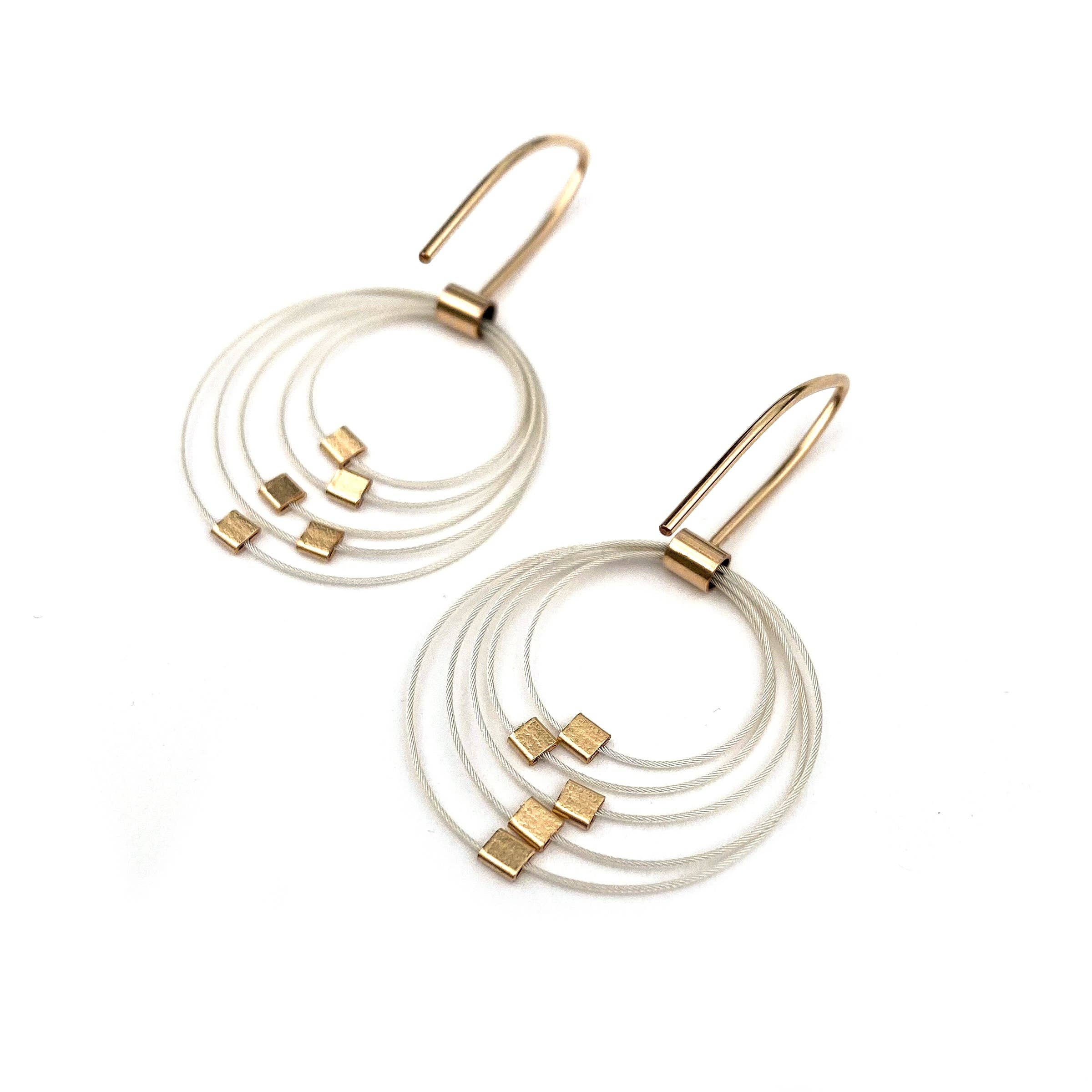 Gold earrings with five hoops that hang down from ear